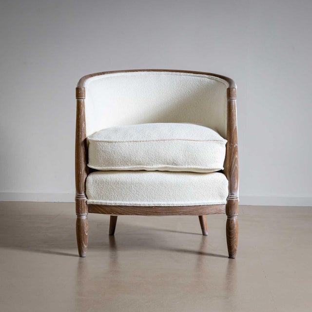 Art Deco armchair in limed oak with rounded backrests and conical legs. The chair was reupholstered in an off-white fabric.