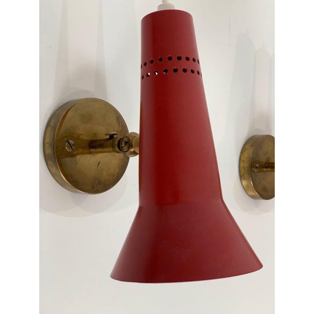 4 red wall lamps produced by Arteluce in 1950 This piece has an attribution mark, I am sure that it is completely...