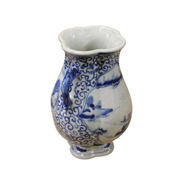 This is a Chinese decorative porcelain vase in Blue and White color finish. The theme is an oriental scroll ancient...