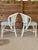 A charming pair of vintage Whitecraft rattan dining chairs featuring woven lattice backs, curved arms, and a timeless...