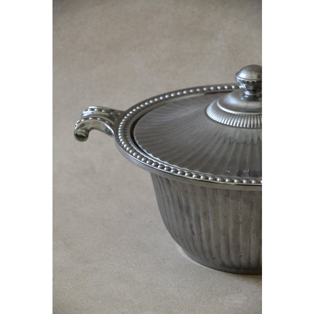 A fluted body with a beaded rim and a domed lid topped with a ball finial, likely made in the early 1900s. Great for...