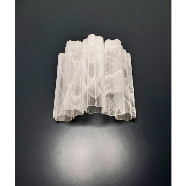Italian vintage pair of wall sconces in Murano glass and nickel-plated metal structure. The armor polished nickel supports...