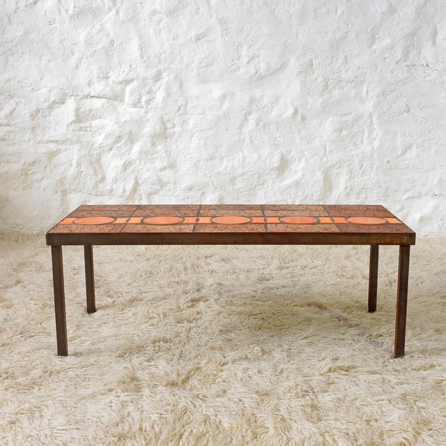 Rectangular low table with a steel frame and a top made of handcrafted tiles. Some are rectangular, textured, fired...