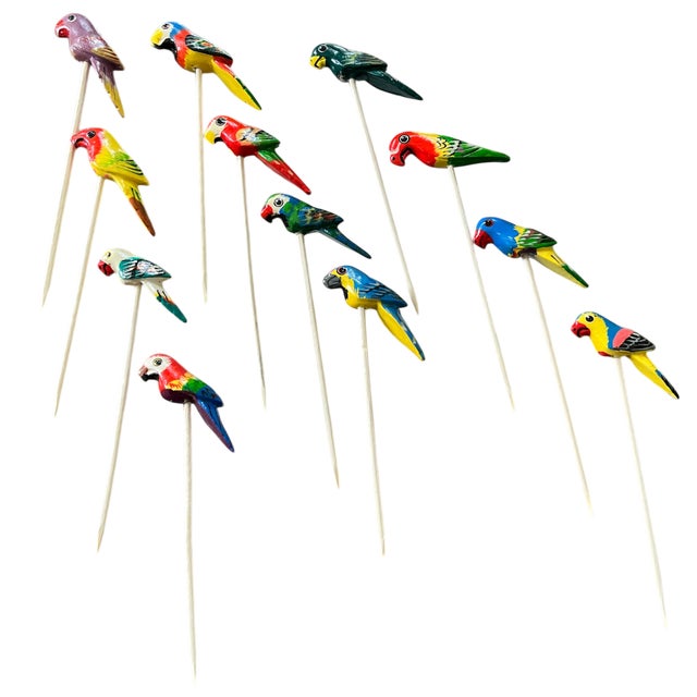 A joyful and highly collectible set of 12 vintage cocktail picks, each topped with a hand-painted parrot in vibrant...