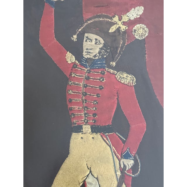 A striking vintage textile portrait depicting a Napoleonic-era hussar officer, rendered in richly layered wool appliqué,...