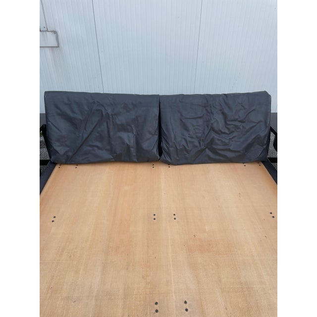 "Morna" double bed in black leather by Afra & Tobia Scarpa for Molteni, made in Italy in the 1980s. The bed frame consists...