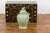 A vintage Chinese crackle green celadon lidded vase from the mid 20th century with stylized foo dog finial and tapering...