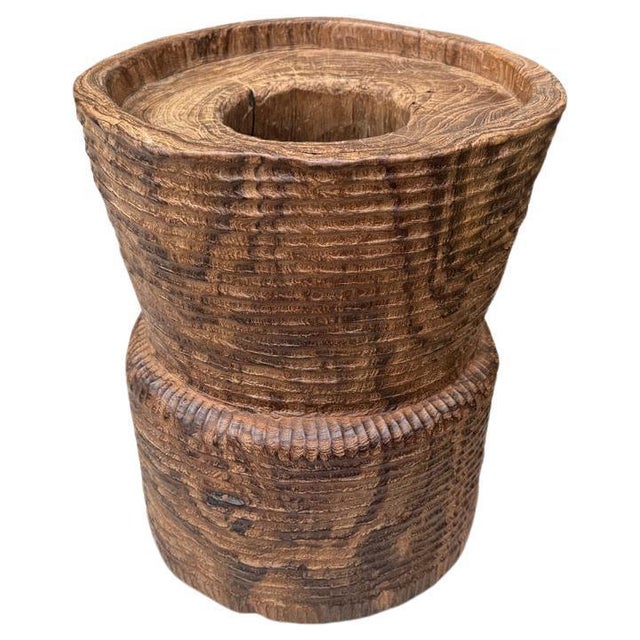 A beautiful ancient mortar originally used to pound rice from Sumatra, is repurposed as an art piece, container or side...
