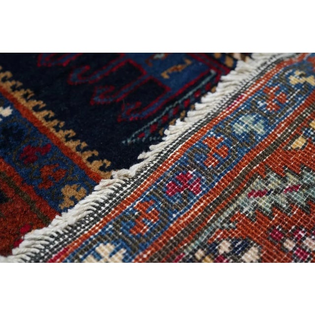 This narrow, NW Persian runner shows a chain of fifteen characteristic medallions in alternating elaborate palmette and...