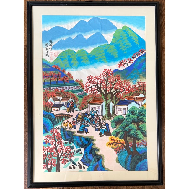 Vintage Chinese-style framed art print featuring a colorful rural village scene with figures, mountains, and flowering...
