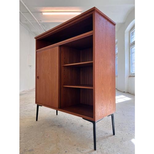 This Danish teak cabinet is an outstanding example of the functional aesthetics of mid-century design. The piece has been...