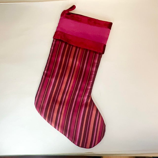 This is a beautiful Silk and Velvet Christmas Stocking from the late Mid-Century. It features a red and pink striped silk...