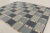 This oversized 11x13 Scandinavian rug showcases a geometric plaid-inspired design in powder blue, denim, ivory, beige, and...