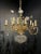 A circa 1930’s French gilt metal and crystal chandelier with 12 lights. Floral design and crystal bottom part.