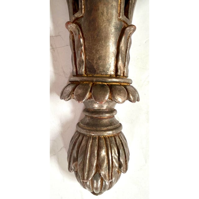 Pair of Italian 20th century silver giltwood brackets fully embellished with classic details including laurel leaf carving...