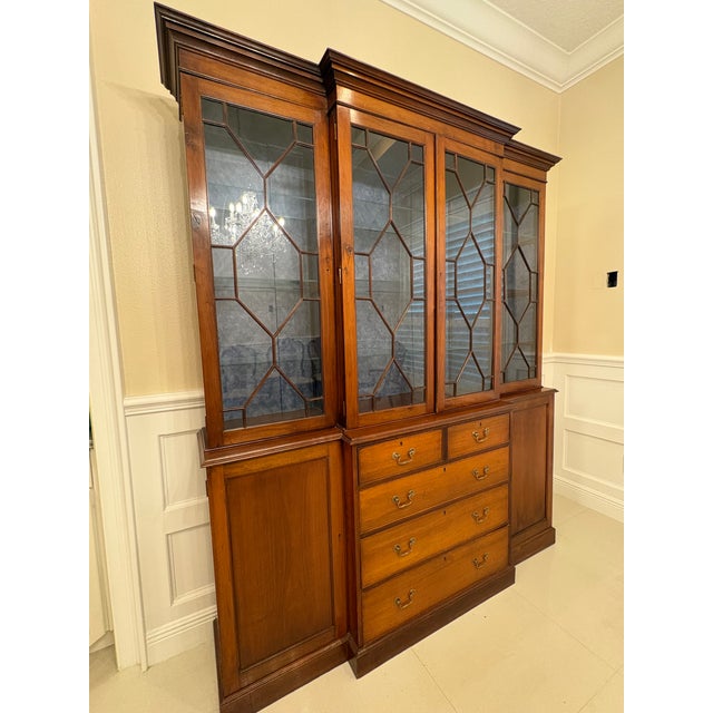 A magnificent and commanding George III / Chippendale style breakfront library bookcase in solid mahogany — the kind of...