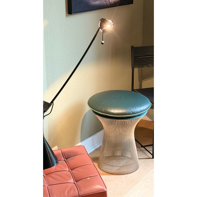 A timeless classic: the exquisite Platner Wire stool in silver nickel with a green leather cover for Knoll International....