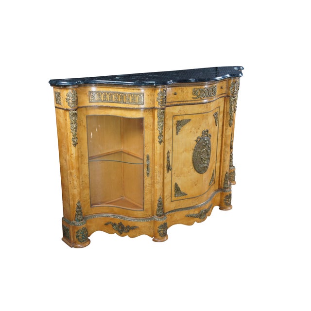 A beautiful French Empire style Buffet Cabinet. Made in Egypt, circa 1980s. Features a serpentine form with a marble top...