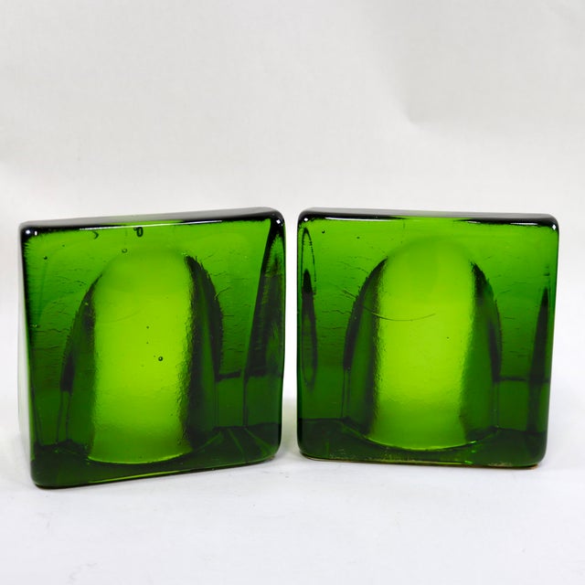 This pair of green wedge bookends with arch cutouts is a striking example of mid-century modern glass design, attributed...