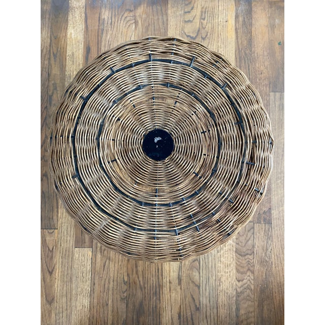 A charming mid-century French stool with a plump, woven rattan/wicker seat in a classic pouf silhouette, set atop three...