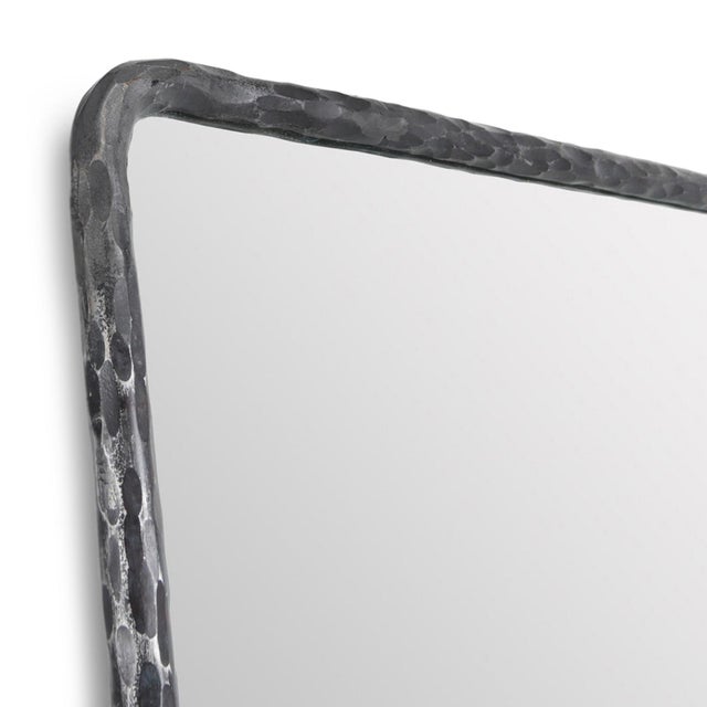 Full-length/floor mirror framed in hand-hammered iron with texture and character. Its slender profile and softly rounded...