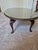 This is a classic Queen Anne style oval coffee table. It is crafted from a rich, warm hardwood—typically cherry or...