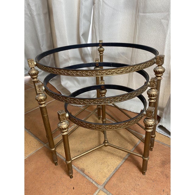 Nesting brass tables from the 1960s/70s. ‼️ Sold without tabletops. Each table features a decorative molding, fluted legs,...