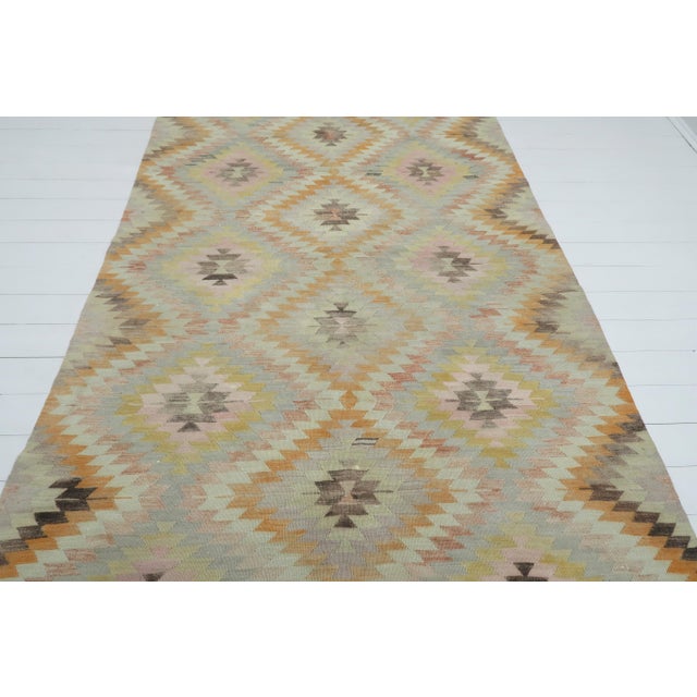 This Turkish Kilim rug hosts an intriguing pallet of vibrant rich and pastel colourways complementing a very Turkish sense...