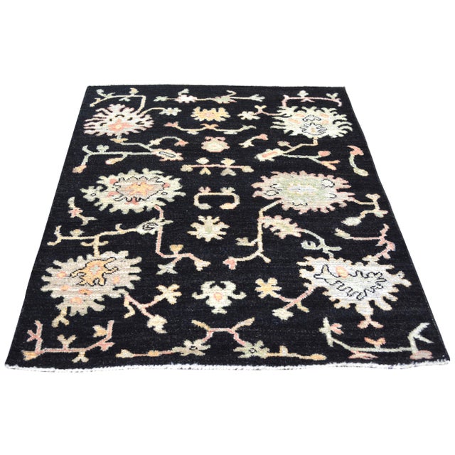 Hand-knotted with care using traditional rug making techniques, this wool rug blends timeless craftsmanship with a modern...