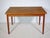 Extendable Danish design dining table in teak from the 1960s. Simple, clean design with slender, tapered legs and a...
