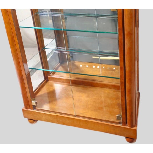 This is a handsome pair of neo-classical Biedermeier style display cabinets by Hickory White. They are carved walnut and...