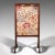 This is an antique needlepoint fire screen. An English, mahogany fireside guard with tapestry screen, dating to the...