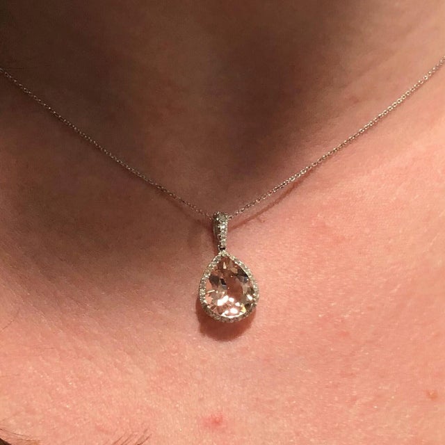 A glowing peach morganite pendant (11×9mm pear shape) accented with sparkling diamonds in solid 14K gold. Elegant and...