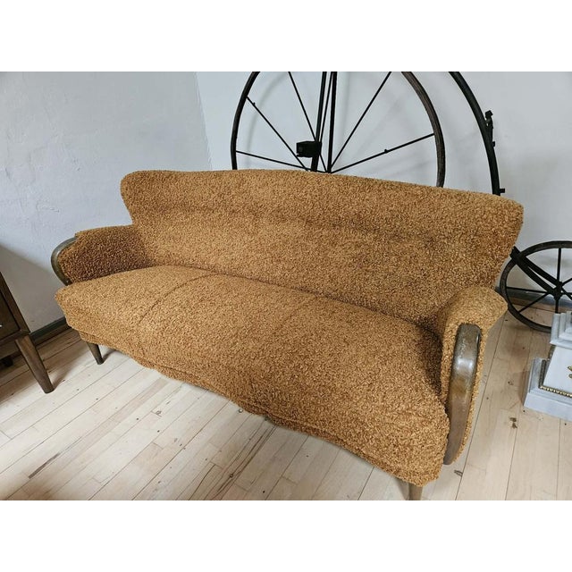 This sofa is a fine example of Scandinavian cabinetmaking from the mid-20th century, showcasing organic form and high-...