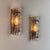A striking pair of sculptural wall lights designed by carl fagerlund for orrefors in the 1970s, featuring richly textured...