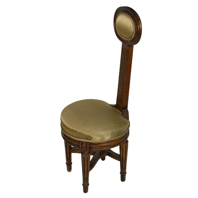 This unique piece exudes charm and character! This elegant Louis XVI style music or vanity chair features an upholstered...