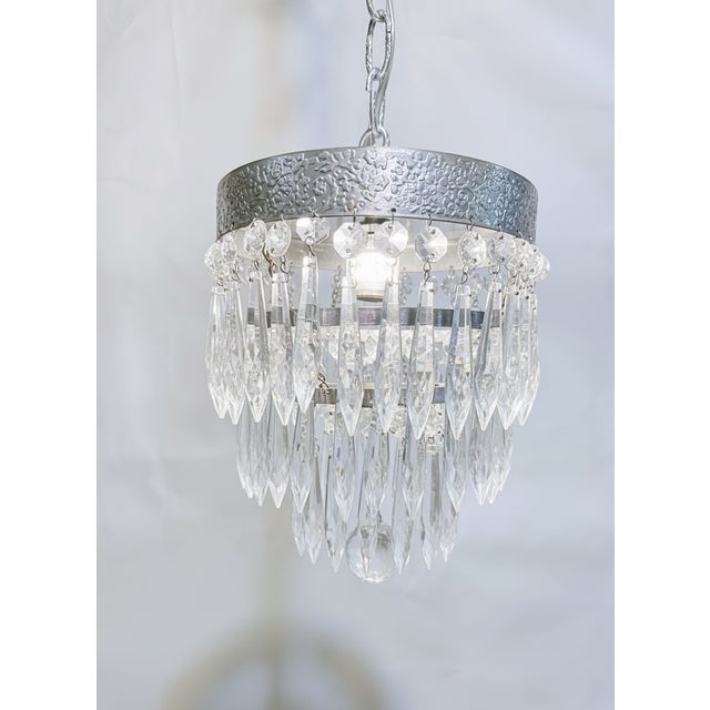 This is adorable vintage brass frame basket chandelier with graduated crystal chain. It has two Edison based sockets that...