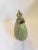 Late 19th Century (c. 1875-1890) muted lime green oval shaped oil storage vessel with stylized animal figure handle.