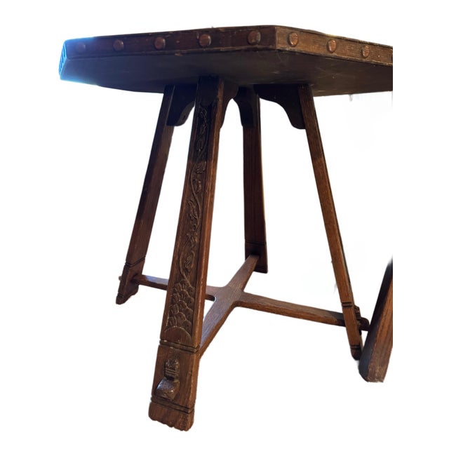 Charming antique solid oak table with three matching chairs, dating to the early 20th century. The table features an...