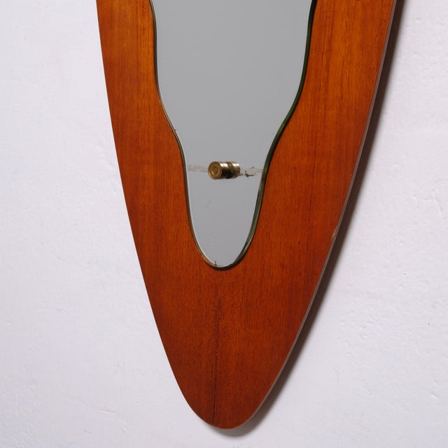 Beautiful oval convex mirror in Italian teak, 1950s design. Dimensions: 128x29 cm Thickness: 2 cm