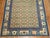 A charming early 20th century Chinese rug with an all over geometric motif in peach, beige, various shades of blue...