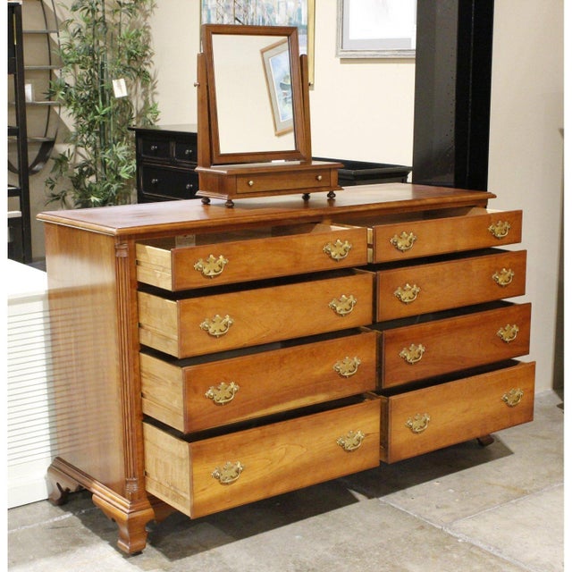 This piece features a classic colonial profile with a warm wood finish and gently curved legs. Eight drawers provide...
