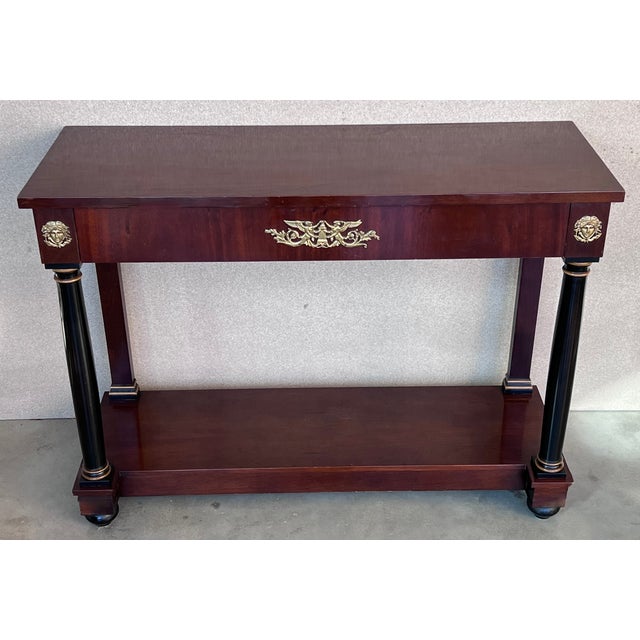 Handsome 19th century Empire style console in walnut adorned with ebonized column legs and rectangular base, Vienna, circa...