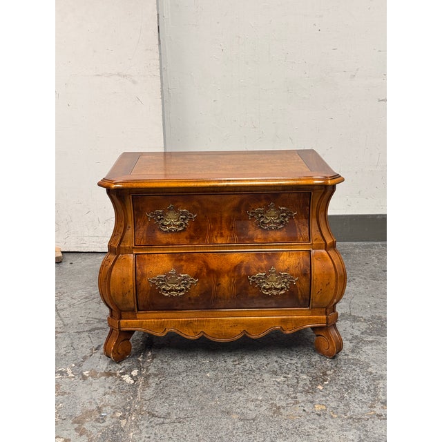 Design Plus Gallery presents a Vintage Louis XV Style Wood Bombe Nightstand from Henredon. This two-drawer piece shows a...