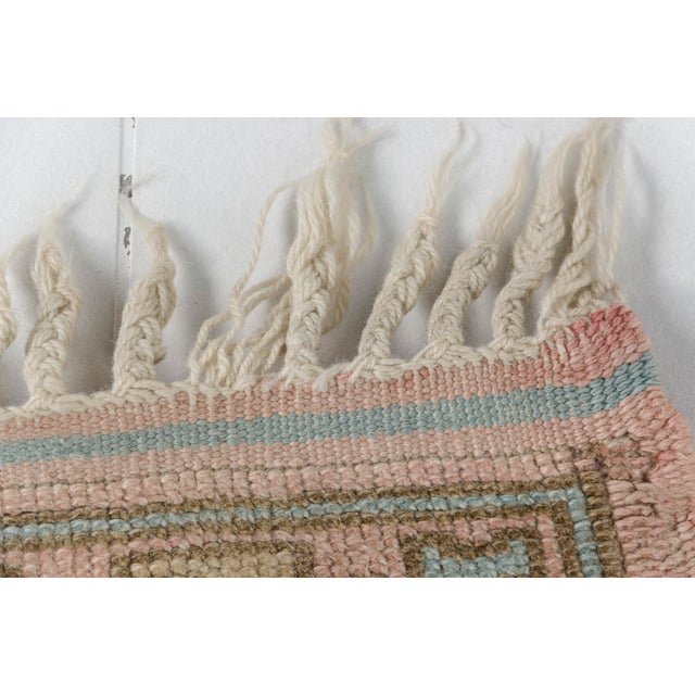 This is a vintage Turkish Oushak rug from the 1960s. The piece was hand-knotted.