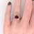 A ruby sits in a vivid red at the centre of this solid 14K yellow gold ring, encircled by sixty earth-mined diamonds. Ruby...
