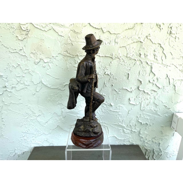 This signed and dated bronze sculpture, “Le Petit Savoyard” (1884), is an authentic work by Emile-Victor Blavier (French,...