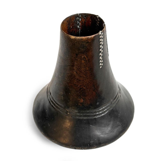 This traditional Ankole wooden milk vessel from Uganda embodies the enduring relationship between pastoral life, skilled...