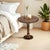 Crafted from solid mango wood, this round pedestal end table showcases timeless character with a warm burnt finish and...