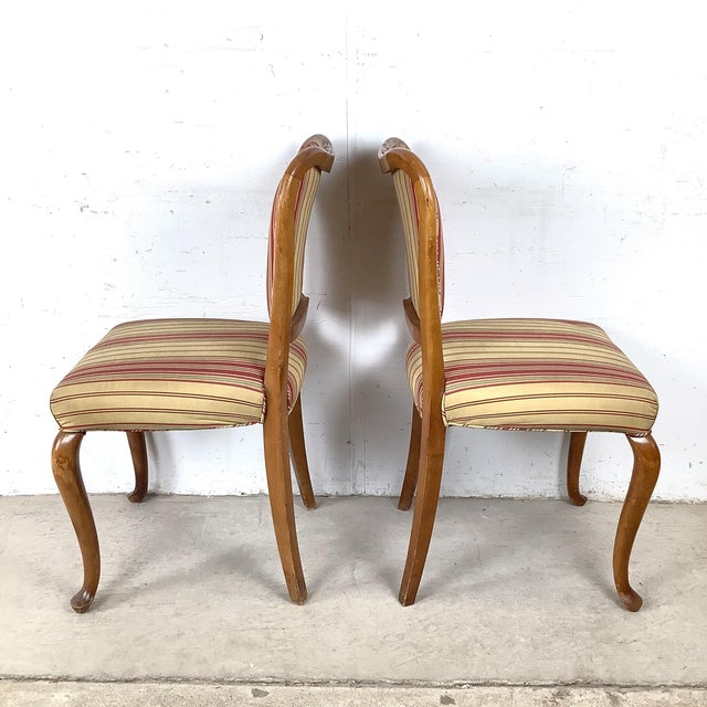 Bring effortless sophistication to your dining room with this charming set of four Queen Anne-style side chairs. Crafted...